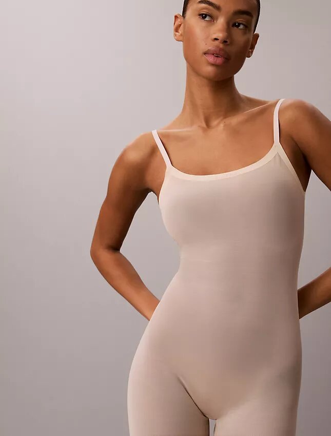 Minimalistisk bodysuit i mesh som slutar vid mitten av låret Minimalistisk bodysuit i mesh som slutar vid mitten av låret