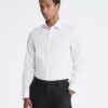 Slim fit-klänning i bomull med fiskbensmönster Slim fit-klänning i bomull med fiskbensmönster